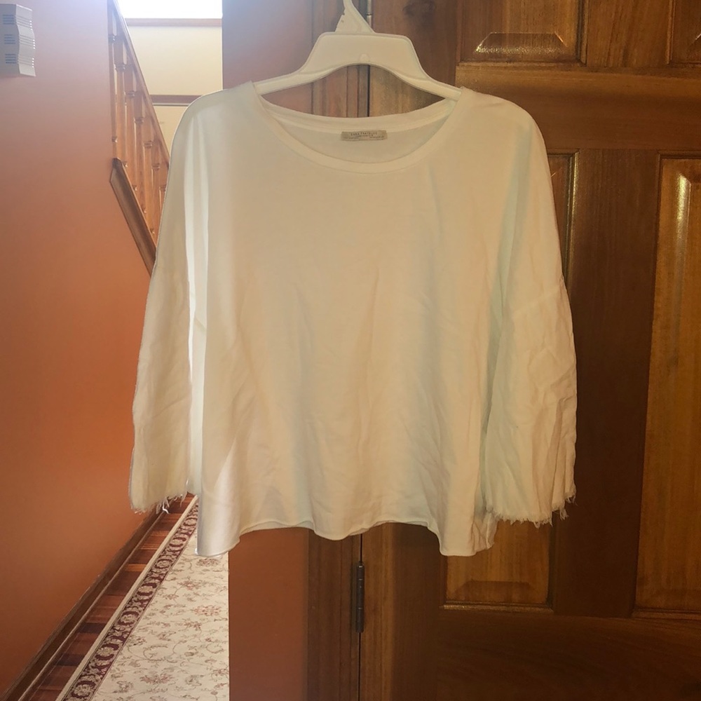 Zara’s white long sleeve top